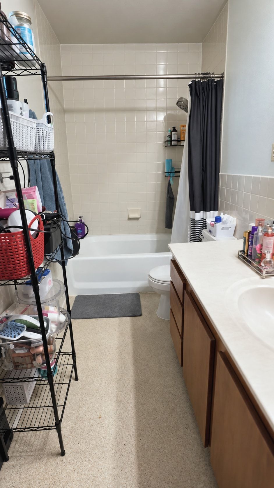 Guest bathroom before: crowded wire shelving and products across the counter